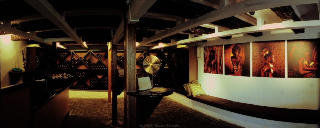 Housed in a 300-year-old Cape Dutch building, the Gold of Africa Museum showcases a stunning collection of precious gold artifacts from across the continent. The contemporary exhibitions, respecting the historic structure, sparkle under delicate suspended lighting, casting vibrant shadows on the old brick walls and timber floors. Completing the experience are a restaurant and a glassed jeweler workshop within the complex.